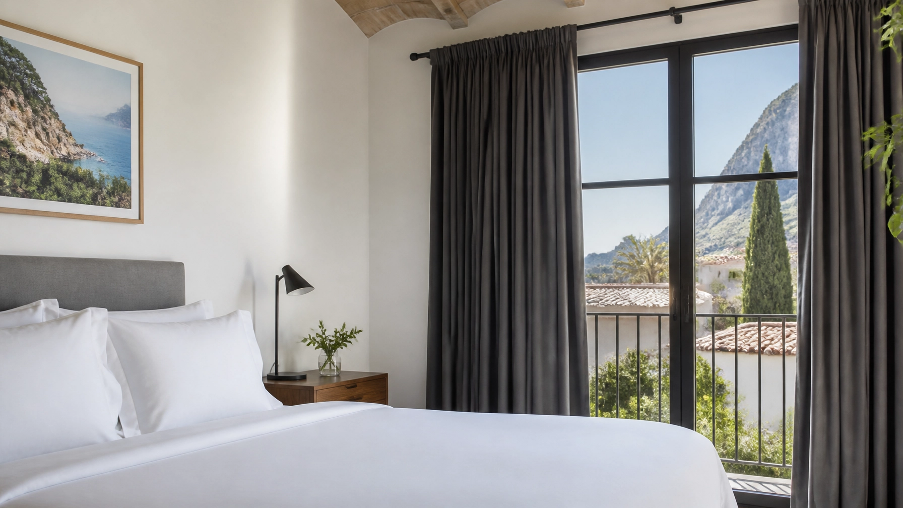 A bright bedroom in a Spanish villa featuring crisp white linens and elegant blackout curtains