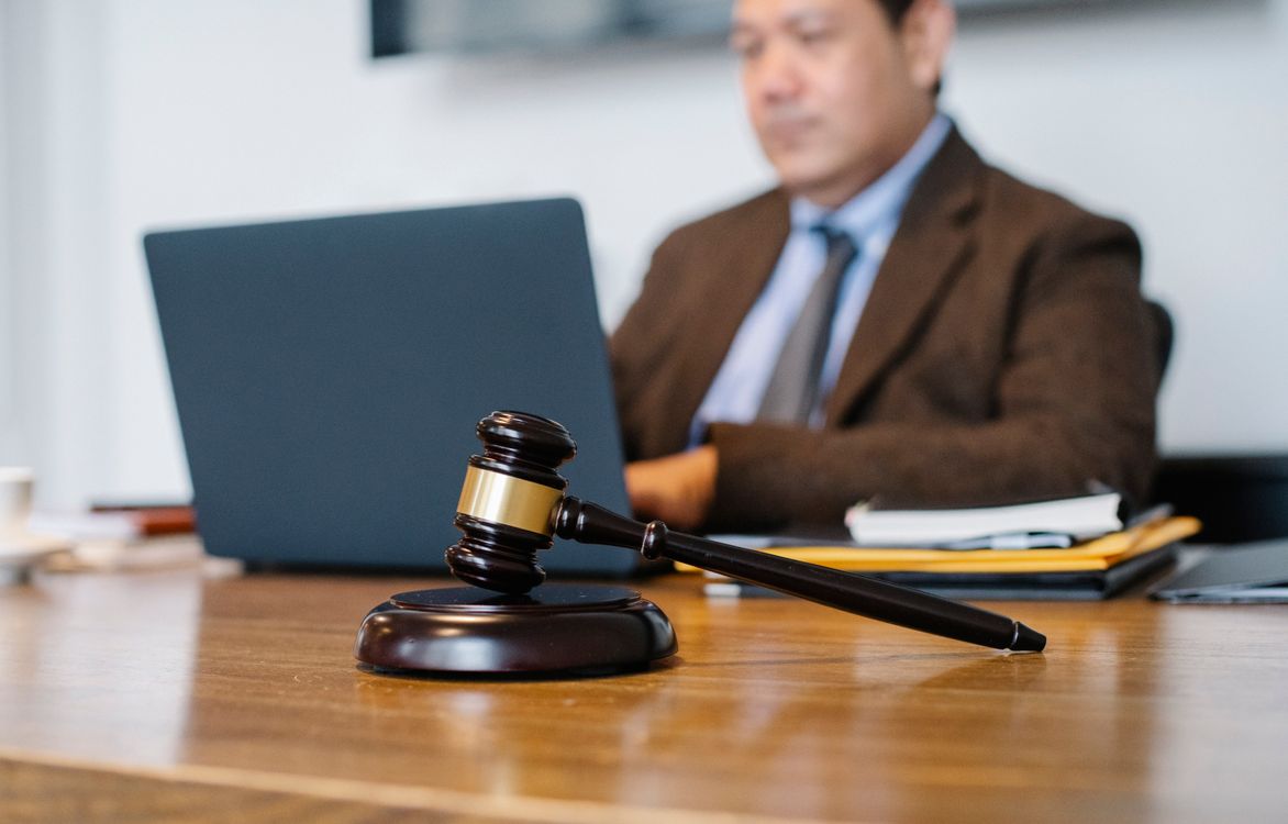 Laptop and documents on a desk showing legal paperwork